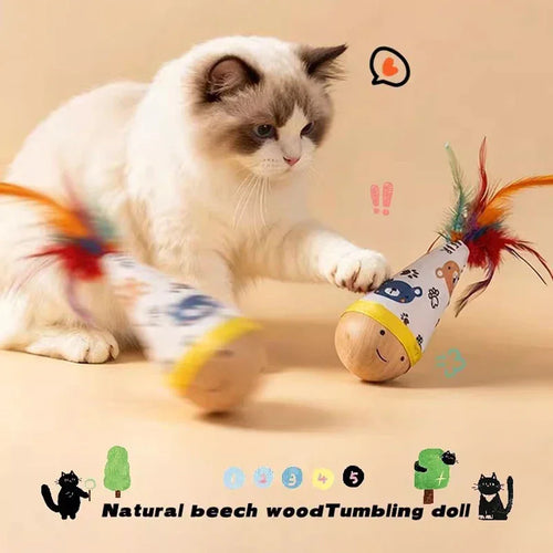 Fluffy cat playing with natural beech wood tumbling doll toy featuring colorful feathers and cute animal print.